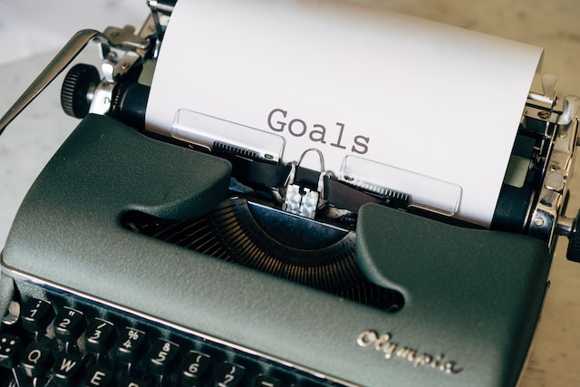 typing your goals on a typewriter