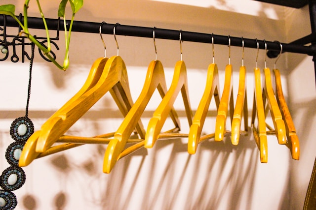 empty closet with wooden hangers after decluttering